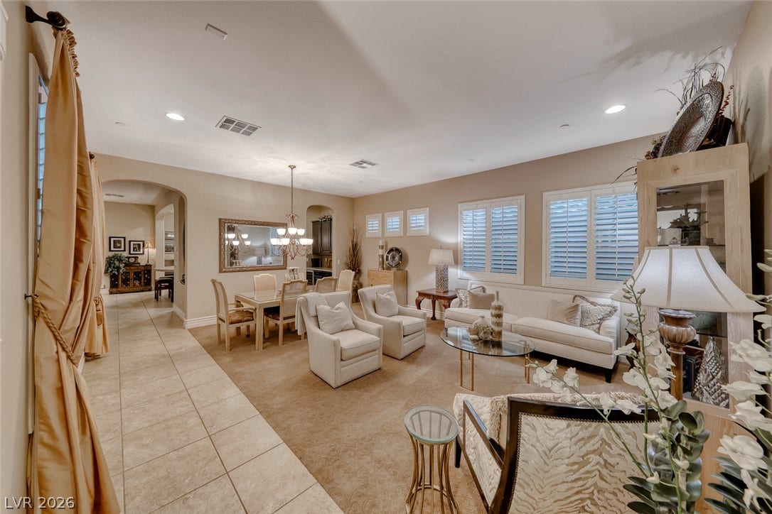 41 Moltrasio Lane, Henderson, NV 89011 An open layout connects the tile-floored corridor to a carpeted living and dining area.