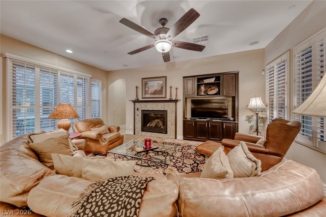 41 Moltrasio Lane, Henderson, NV 89011 An inviting fireplace and built-in media center anchor this comfortable living space.