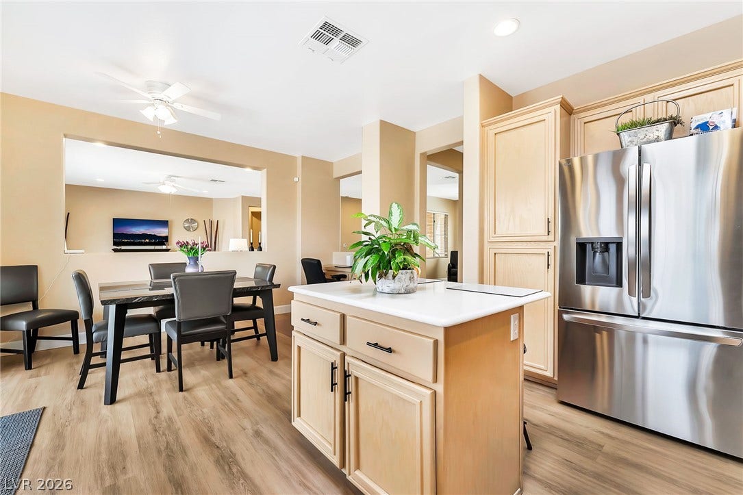 An open kitchen layout flows seamlessly into the dining area with modern flooring throughout.