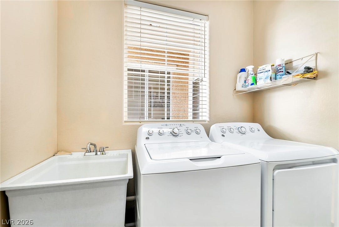 Functional workspace features a deep utility sink and window looking out.