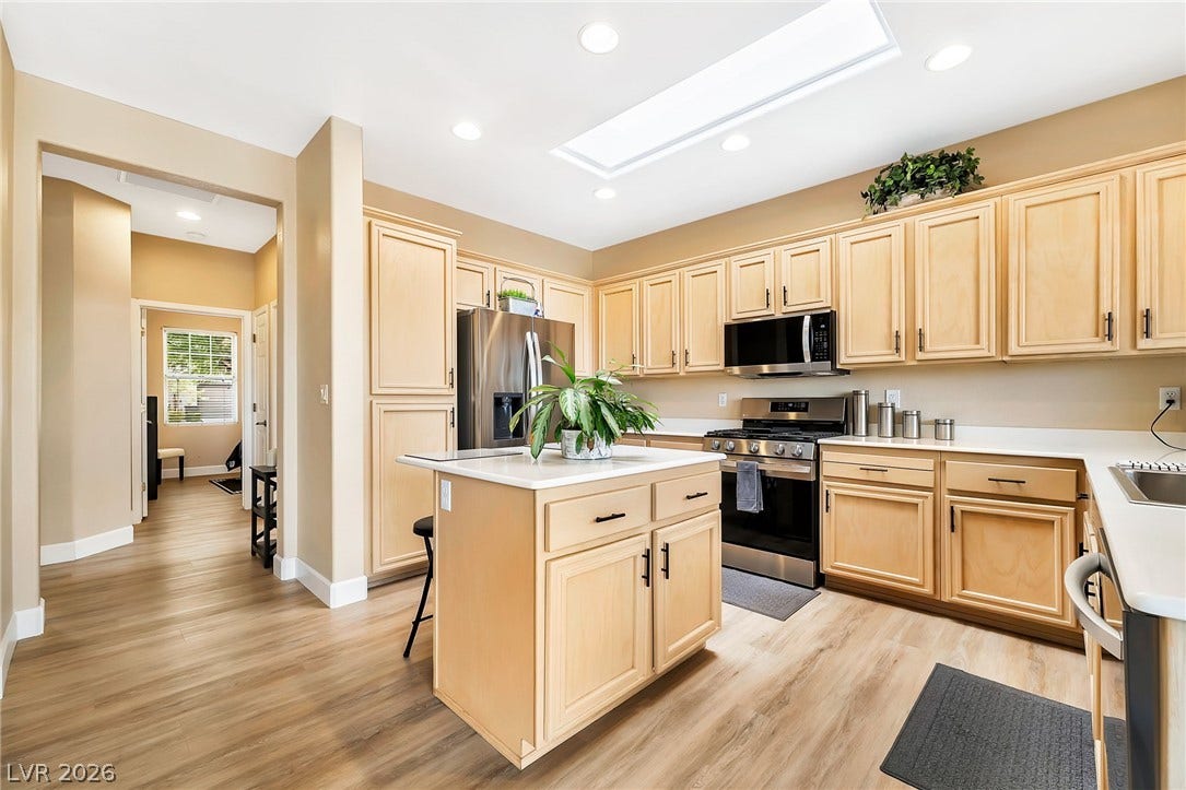Natural light streams through a large skylight over this central island kitchen.