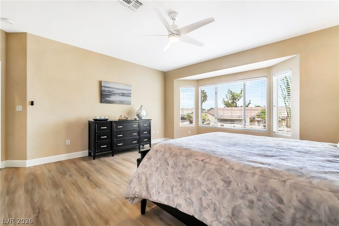 A spacious layout and a large bay window define this relaxing bedroom retreat.
