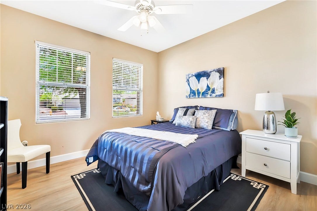 Natural light streams through multiple windows highlighting clean architectural lines and wood-style flooring.