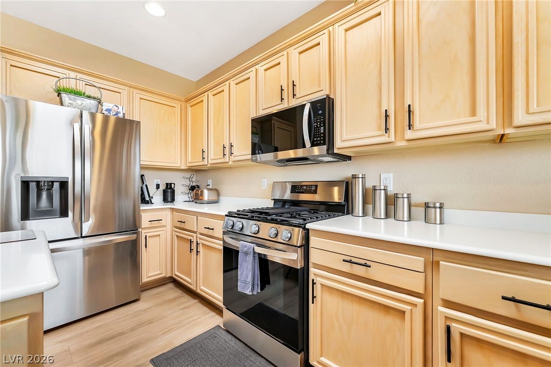 Ample wooden cabinetry and clean countertops define this well-appointed kitchen space.