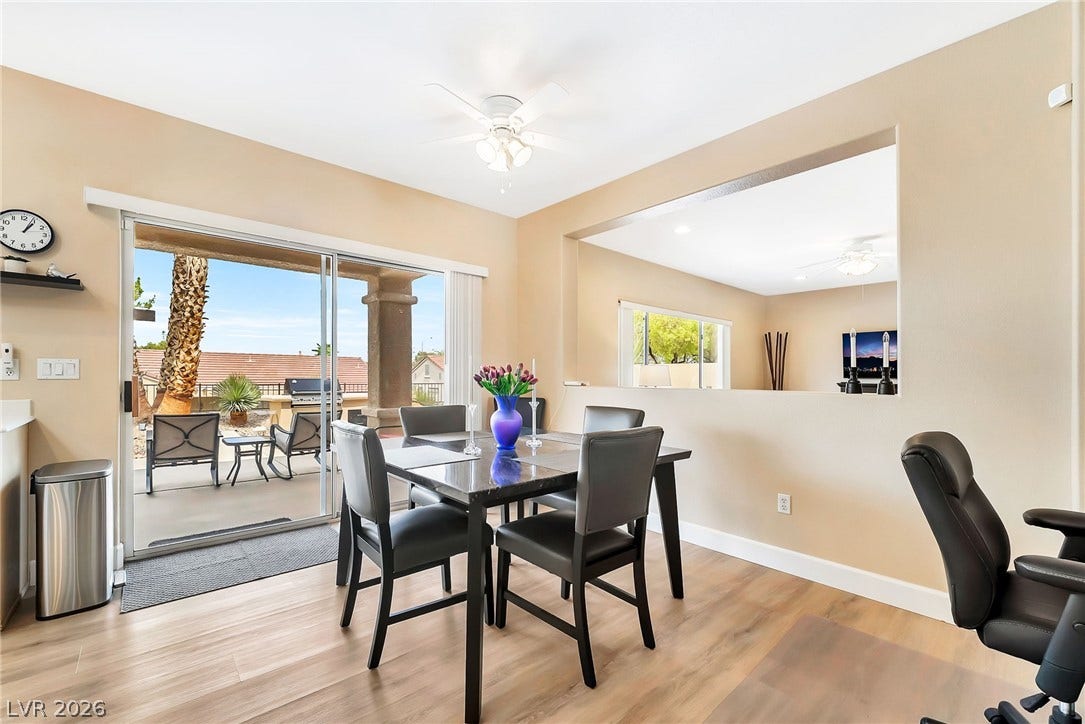 Sliding glass doors connect the dining space directly to the covered back patio.