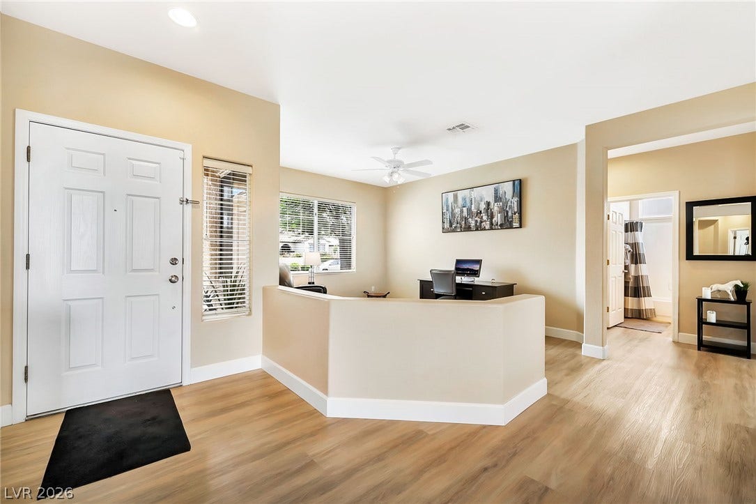 Warm wood-look flooring guides visitors from the entryway into an open and versatile floor plan.