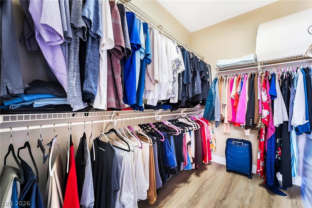 Ample built-in shelving and custom hanging rods maximize storage space in this master closet.