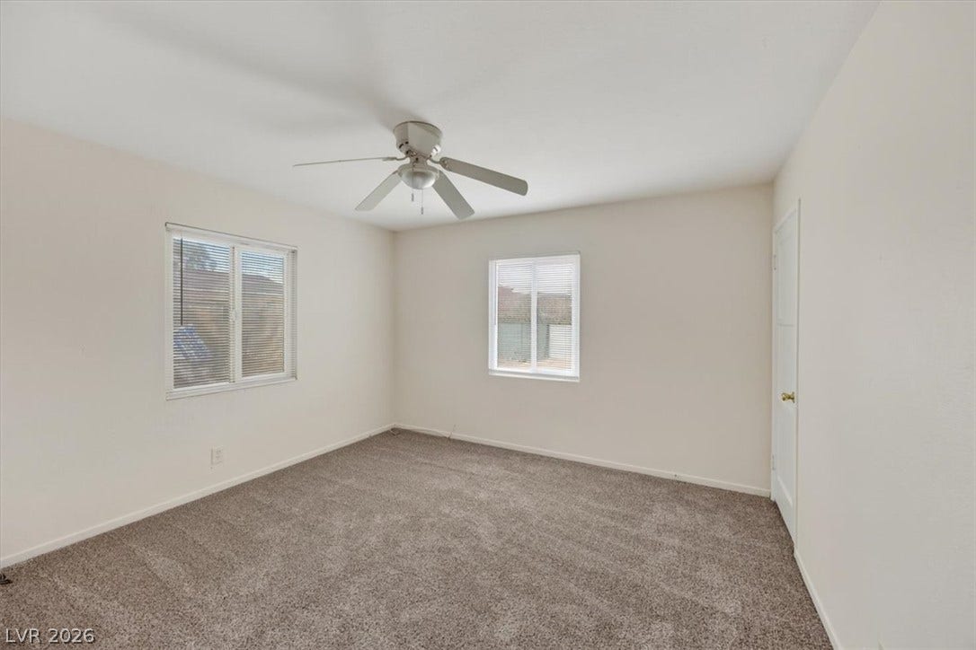 120 W Victory Road, Henderson, NV 89015 Plush wall-to-wall carpeting and multiple windows define this versatile bedroom space.