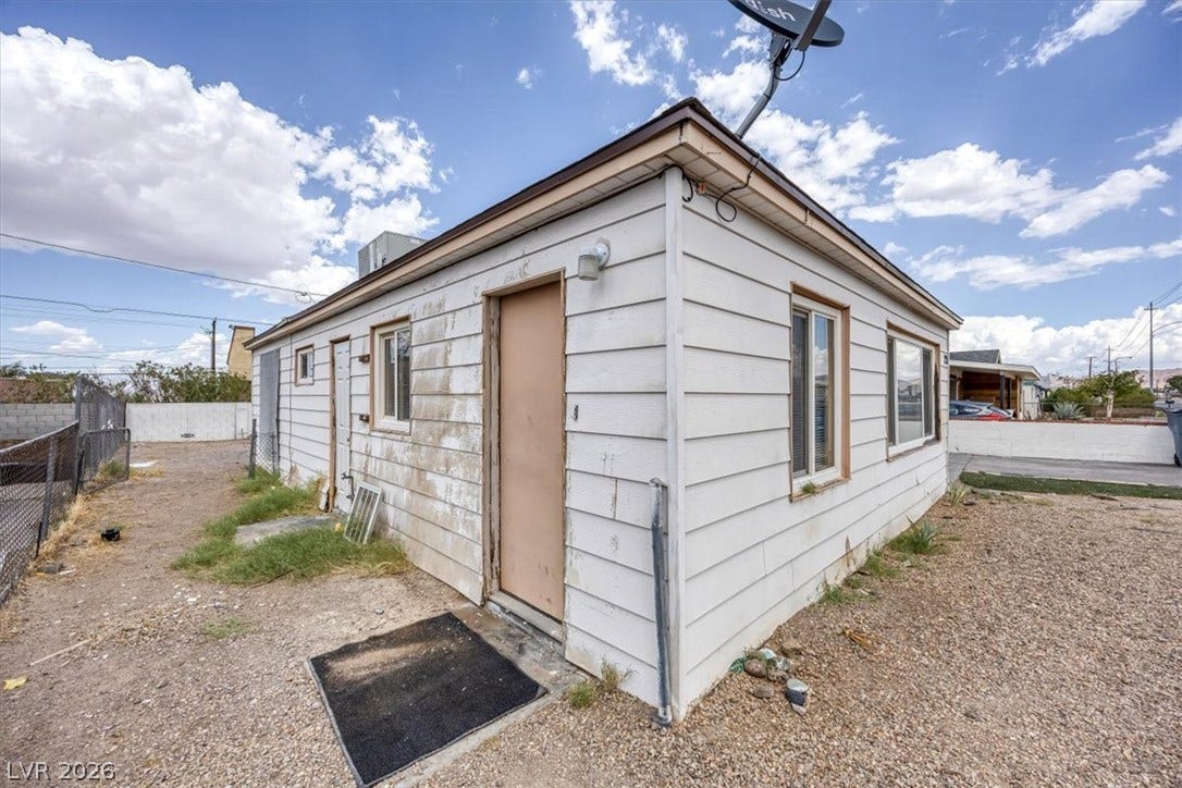120 W Victory Road, Henderson, NV 89015 Detached accessory structure featuring horizontal siding and private entries set on a low-maintenance gravel lot.