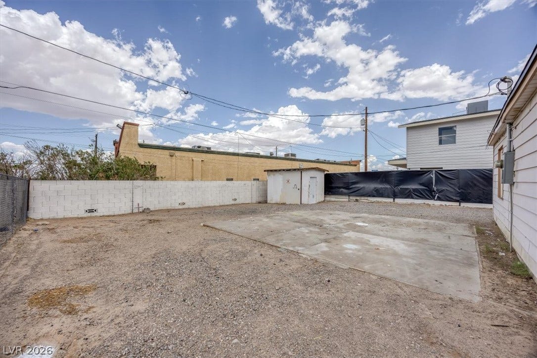 120 W Victory Road, Henderson, NV 89015 A spacious backyard area includes concrete slab flooring alongside a detached storage shed.