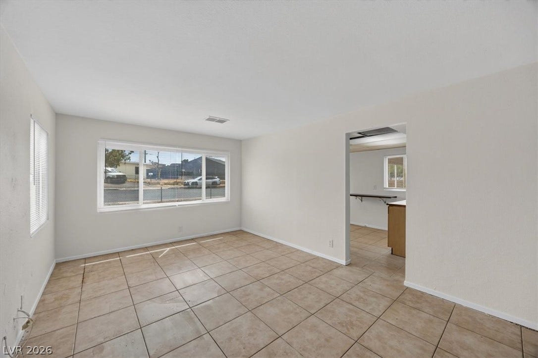 120 W Victory Road, Henderson, NV 89015 Tiled flooring and broad windows anchor this versatile open living space.