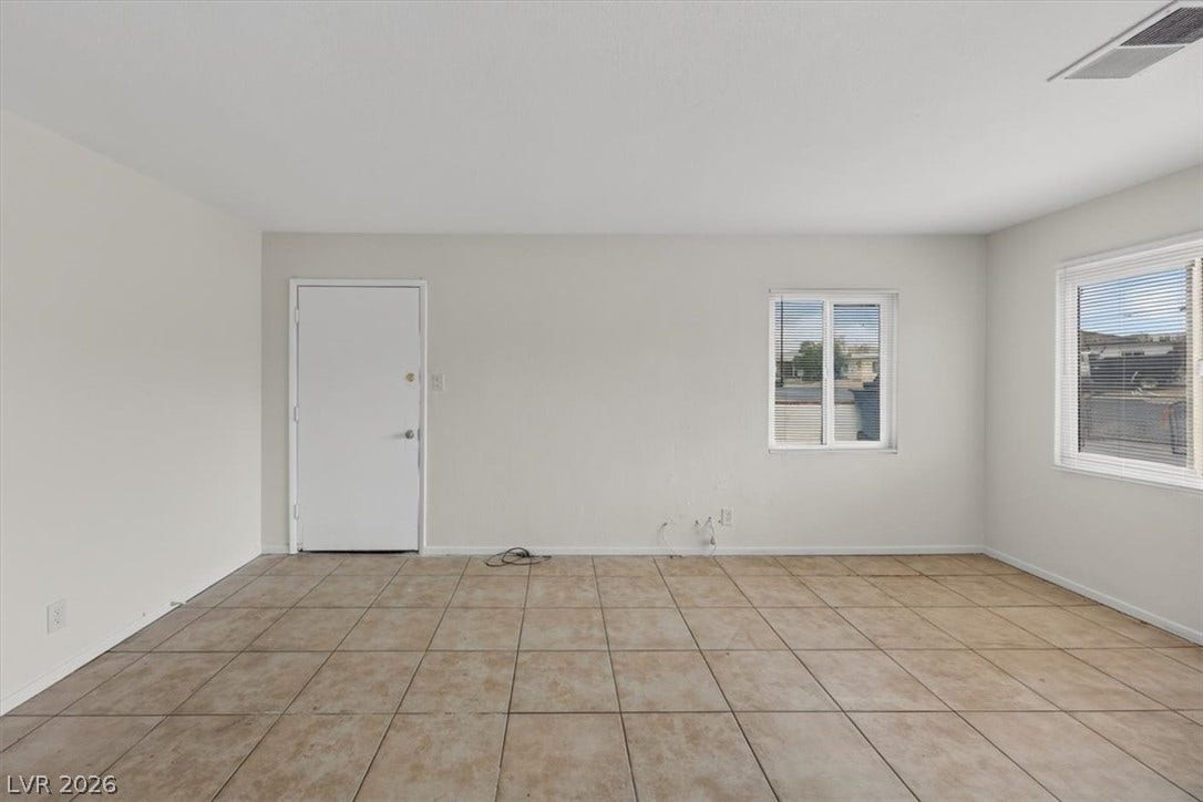120 W Victory Road, Henderson, NV 89015 Durable tile flooring runs throughout this versatile living area featuring multiple windows.