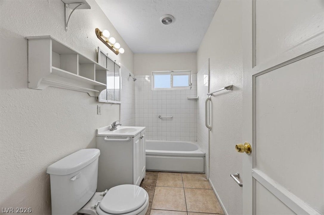 120 W Victory Road, Henderson, NV 89015 Tiled flooring and a classic tub shower combination define this functional bathroom layout.