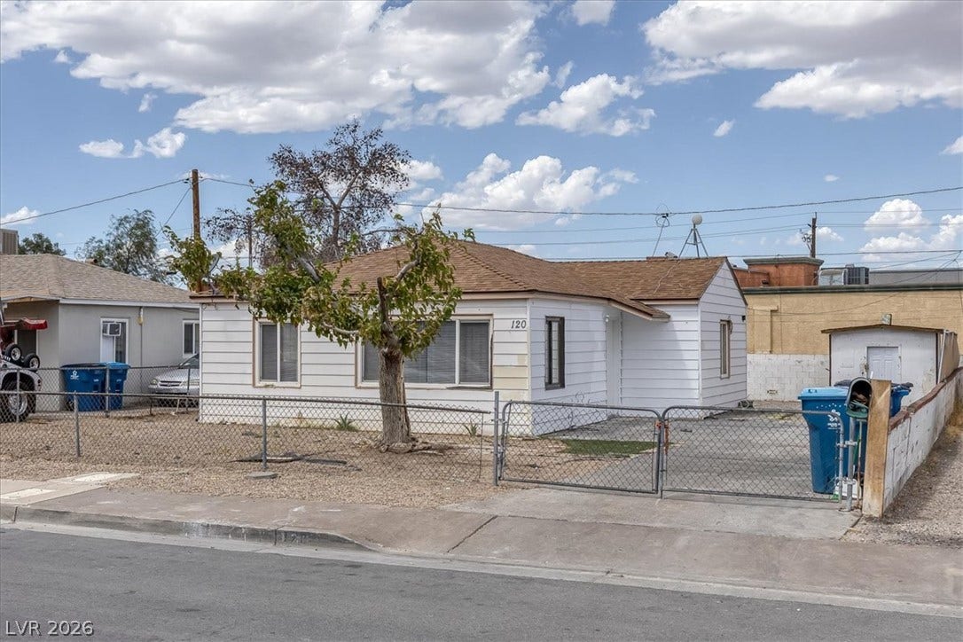 120 W Victory Road, Henderson, NV 89015 A fenced front yard and classic horizontal siding define this single-story home's exterior character.