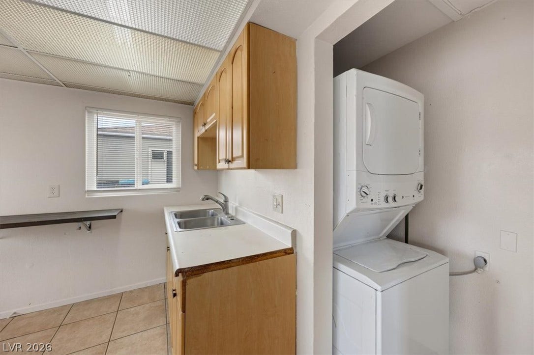 120 W Victory Road, Henderson, NV 89015 Functional utility space features tiled flooring alongside integrated laundry hookups and cabinetry.