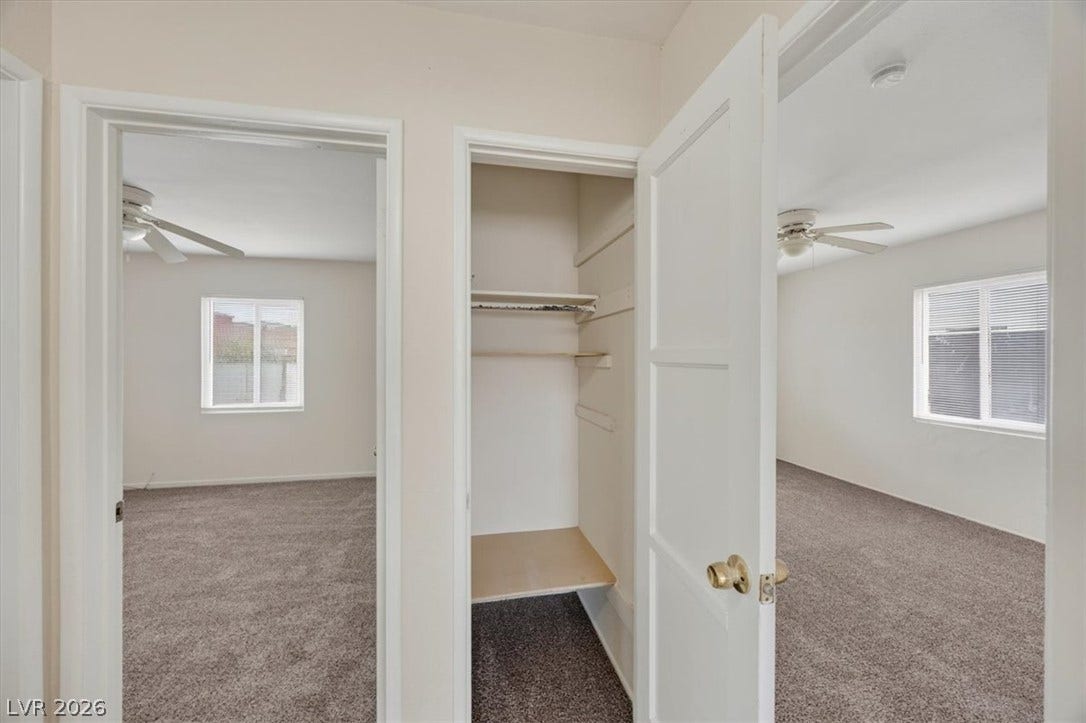 120 W Victory Road, Henderson, NV 89015 A view from the hallway reveals carpeted bedrooms and a built-in storage closet.