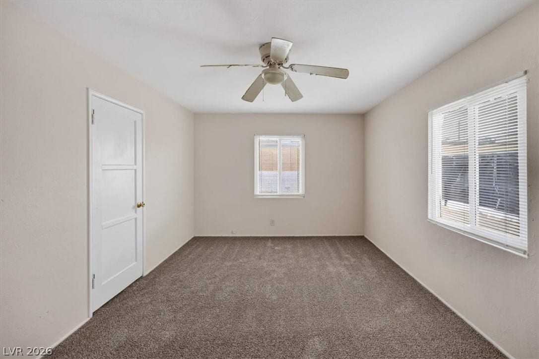 120 W Victory Road, Henderson, NV 89015 Plush carpeting and natural light define this versatile secondary bedroom space.