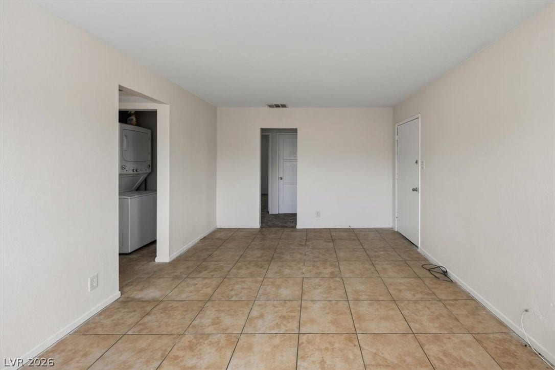 120 W Victory Road, Henderson, NV 89015 Tiled flooring anchors this open living area with convenient access to the in-unit laundry.