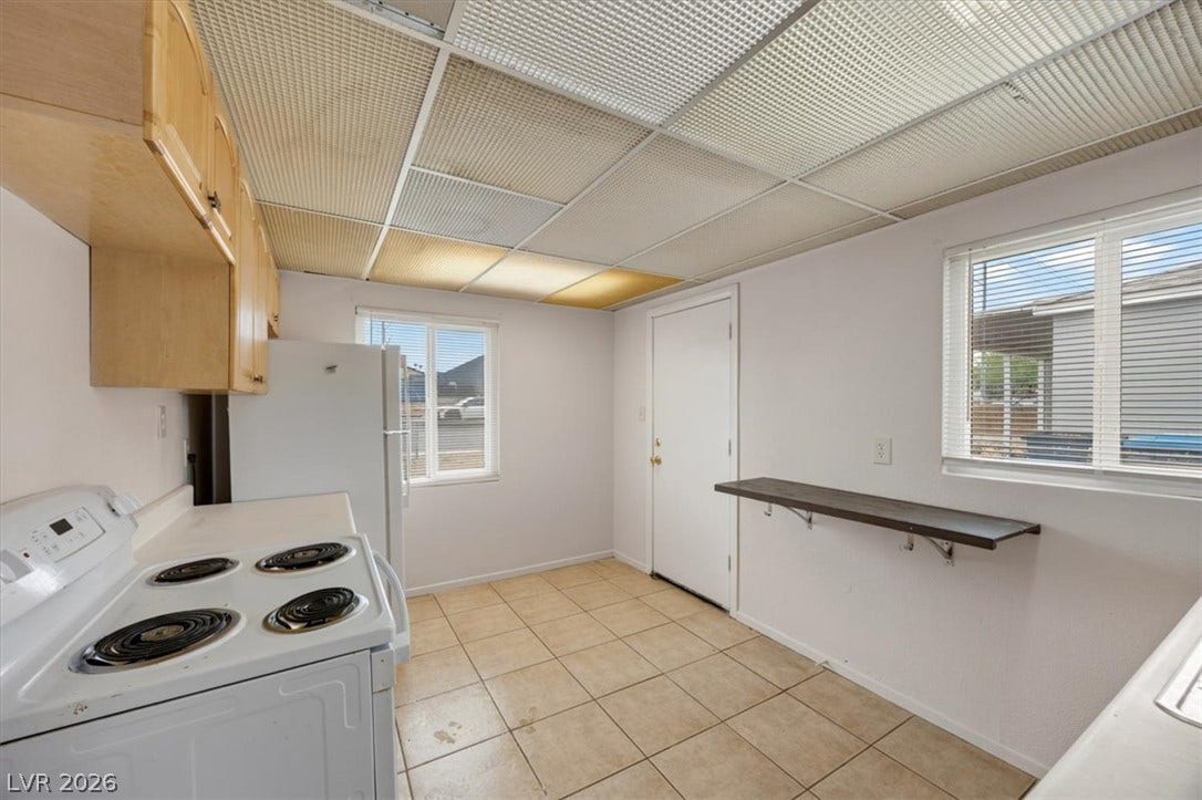 120 W Victory Road, Henderson, NV 89015 Functional kitchen design showcases durable tile flooring alongside classic wood cabinetry.