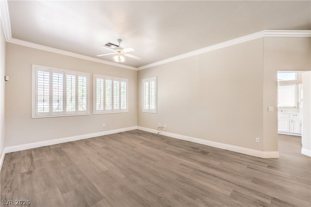 10700 Grand Cypress Avenue, Las Vegas, NV 89134 Crisp crown molding accents the clean lines of this open living space with wood-look flooring.