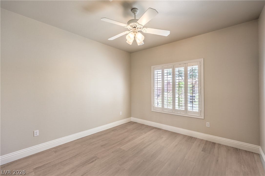 10700 Grand Cypress Avenue, Las Vegas, NV 89134 Hardwood floors and classic plantation shutters anchor this versatile secondary bedroom space.