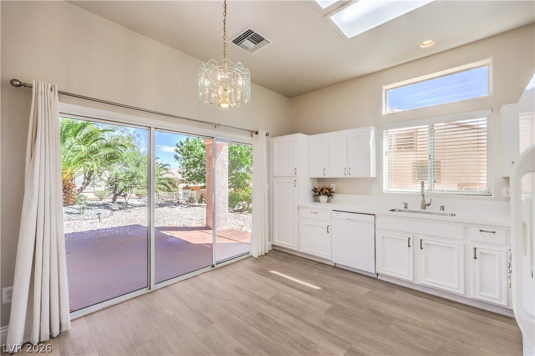 10700 Grand Cypress Avenue, Las Vegas, NV 89134 Sliding glass doors open from the dining area to a sun-drenched patio.
