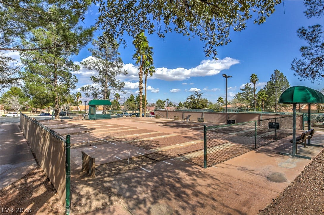 10700 Grand Cypress Avenue, Las Vegas, NV 89134 Fenced shuffleboard courts offer outdoor recreation opportunities under clear desert skies.