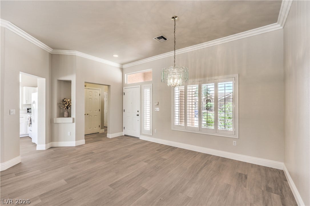10700 Grand Cypress Avenue, Las Vegas, NV 89134 Crisp crown molding and durable wood-look flooring define this welcoming open dining room space.