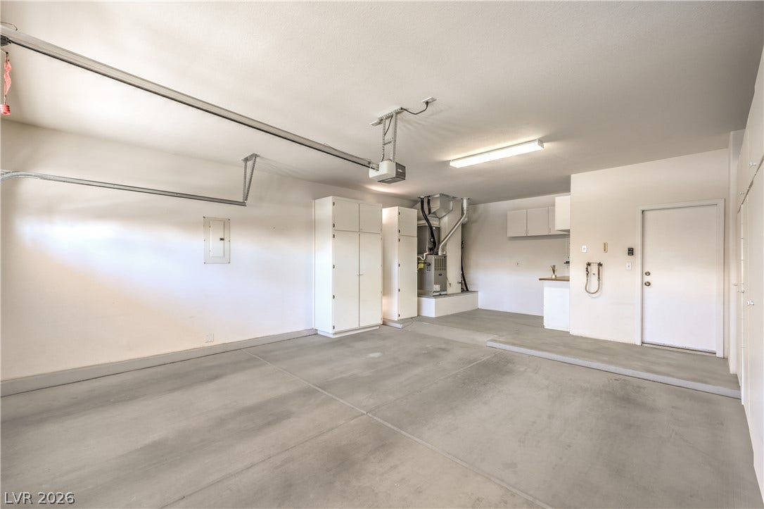 10700 Grand Cypress Avenue, Las Vegas, NV 89134 Smooth concrete floors and abundant built-in storage cabinets define this pristine, functional utility space.