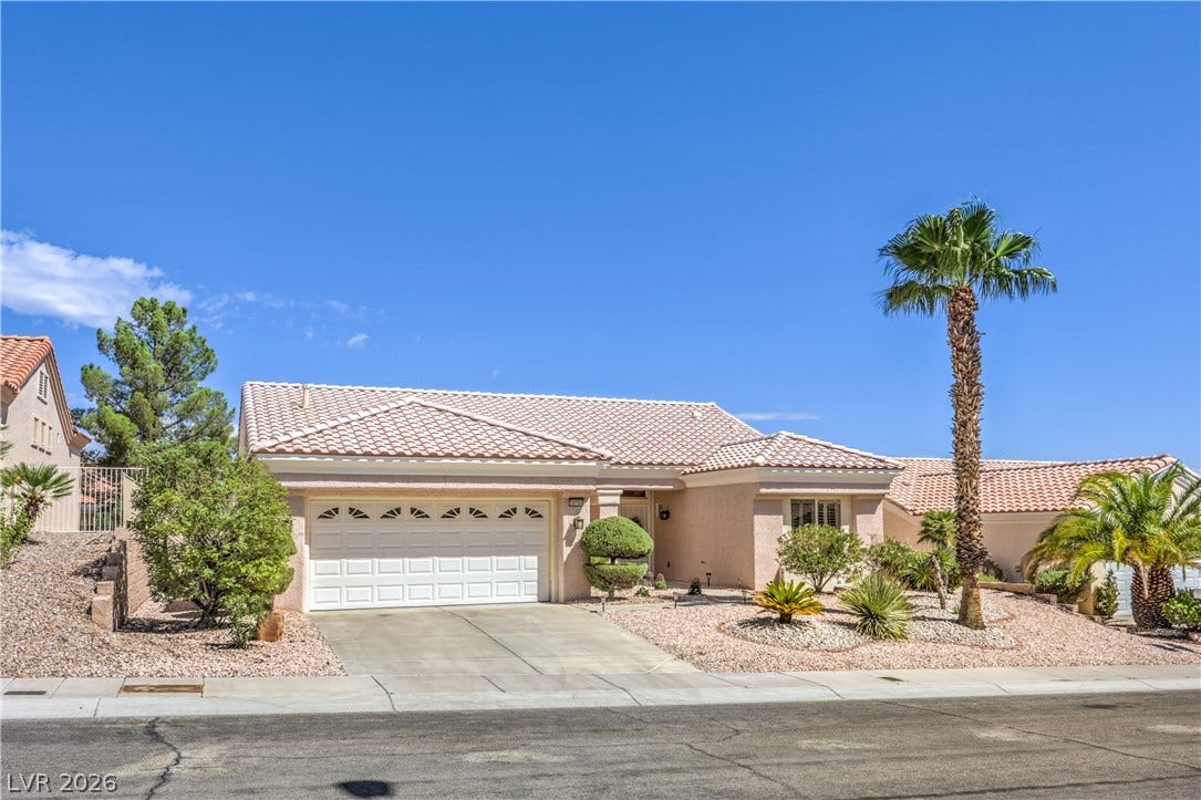 10700 Grand Cypress Avenue, Las Vegas, NV 89134 Classic desert landscaping frames this single-story stucco home topped by a tile roof.