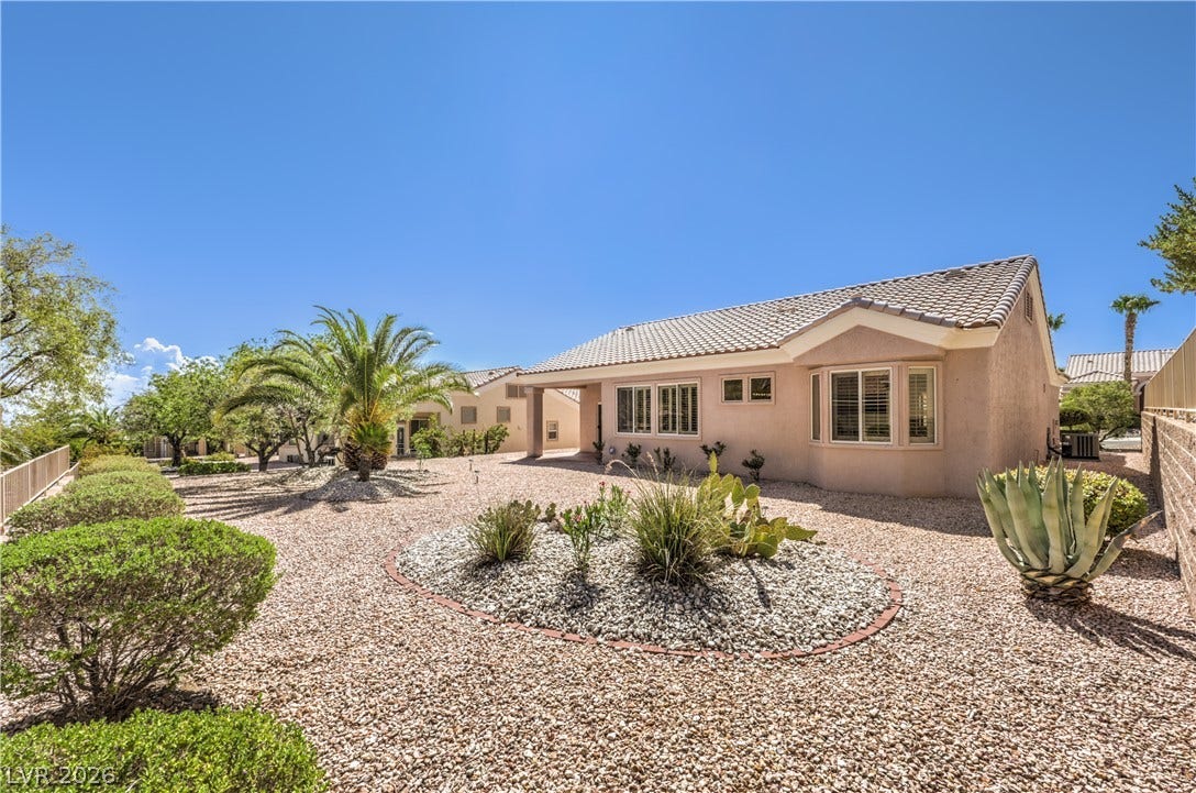 10700 Grand Cypress Avenue, Las Vegas, NV 89134 Low-maintenance desert landscaping surrounds this classic stucco home with a tile roof.