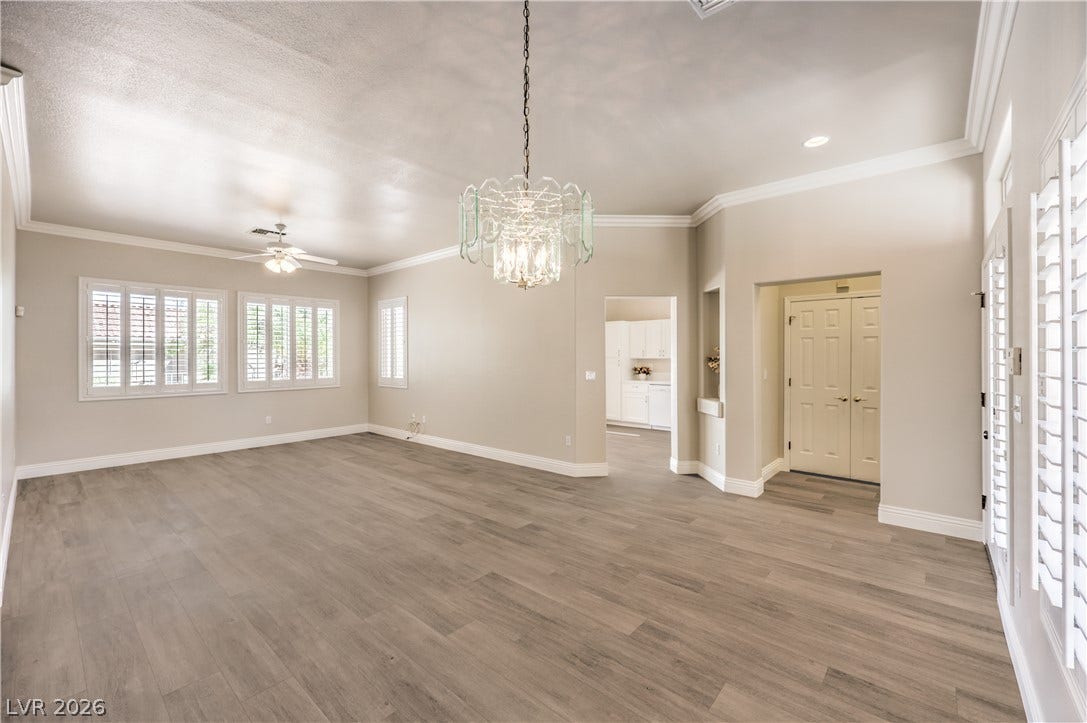 10700 Grand Cypress Avenue, Las Vegas, NV 89134 Clean modern flooring and elegant crown molding define this open, airy living space.