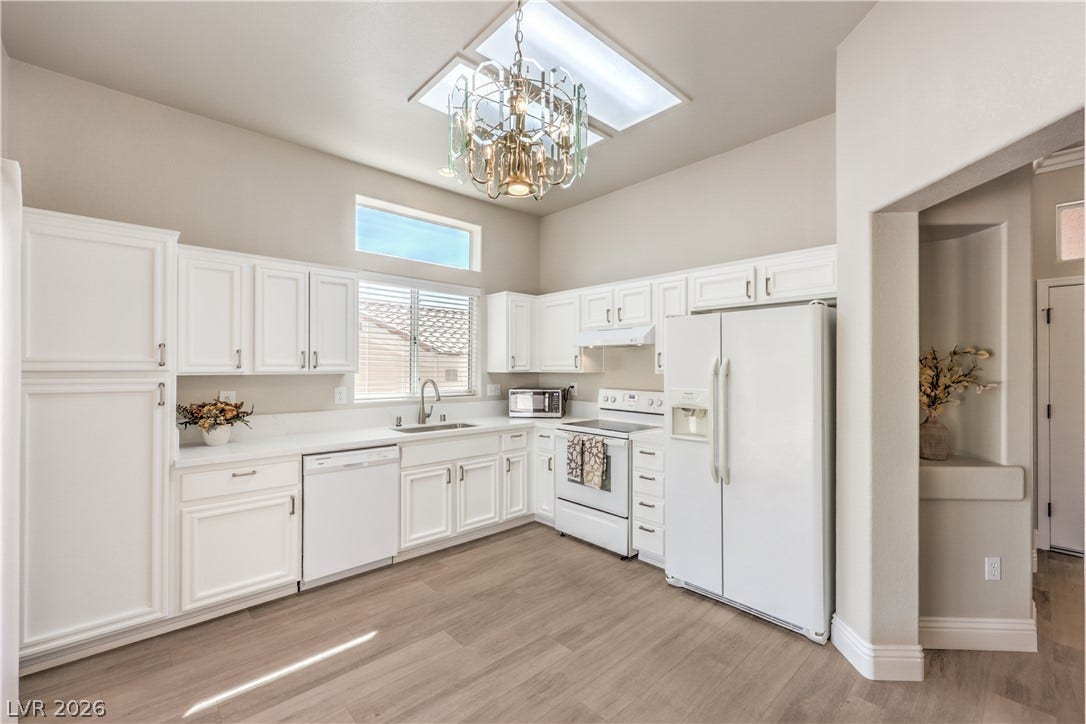 10700 Grand Cypress Avenue, Las Vegas, NV 89134 High ceilings and a bright skylight illuminate this kitchen with generous cabinet space.