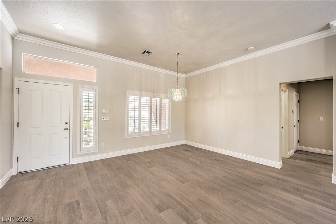 10700 Grand Cypress Avenue, Las Vegas, NV 89134 Gleaming hardwood floors and classic crown molding define this welcoming entryway.
