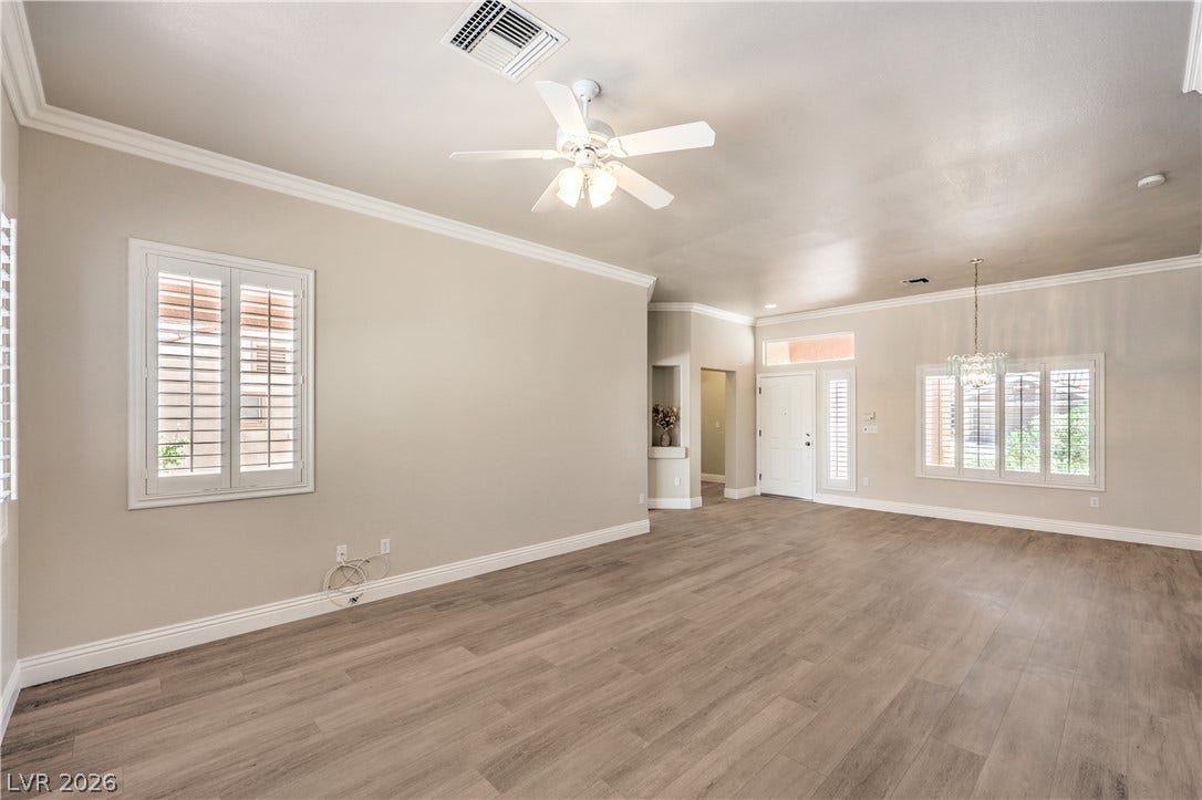 10700 Grand Cypress Avenue, Las Vegas, NV 89134 Crisp crown molding accents the airy, open-concept living area with handsome wood-look flooring.