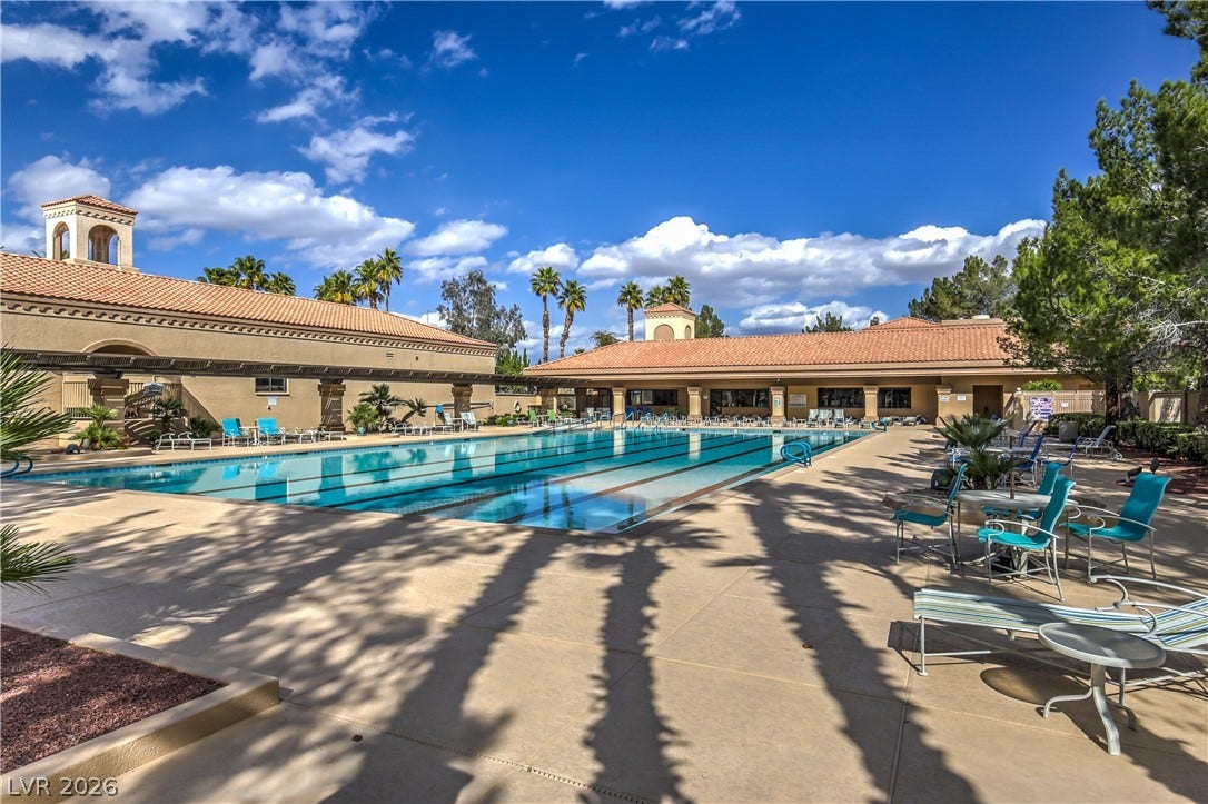 10700 Grand Cypress Avenue, Las Vegas, NV 89134 An expansive outdoor swimming pool is surrounded by spacious concrete decking and tiled roofs.