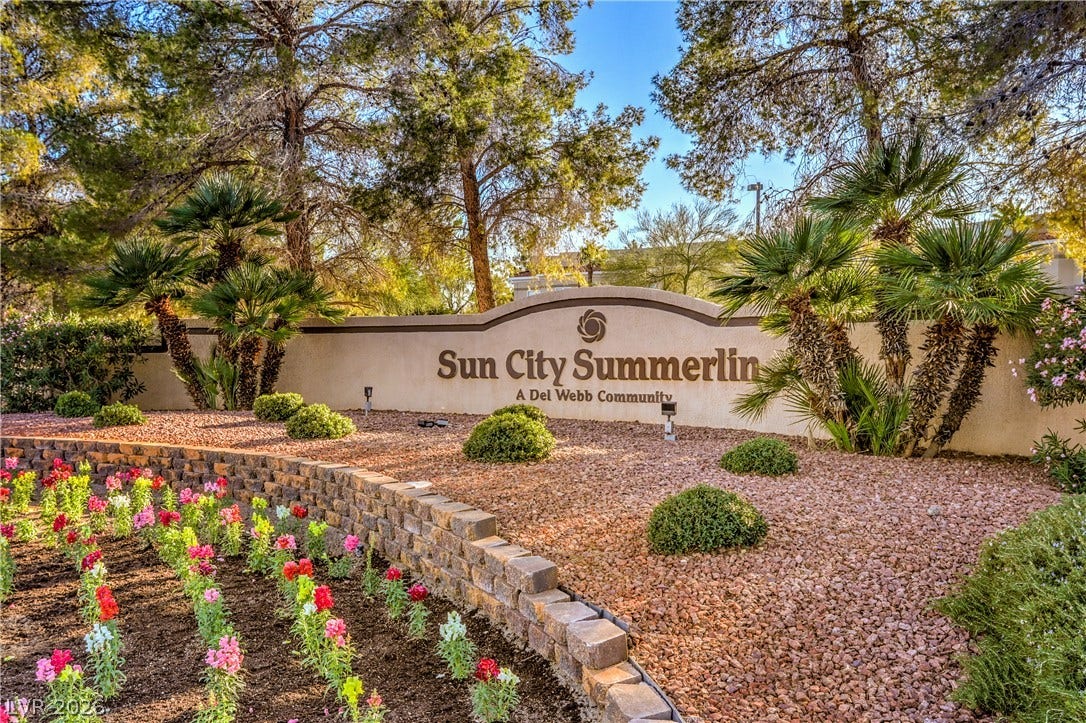 10700 Grand Cypress Avenue, Las Vegas, NV 89134 Mature trees and colorful seasonal flowers frame the community entrance monument.