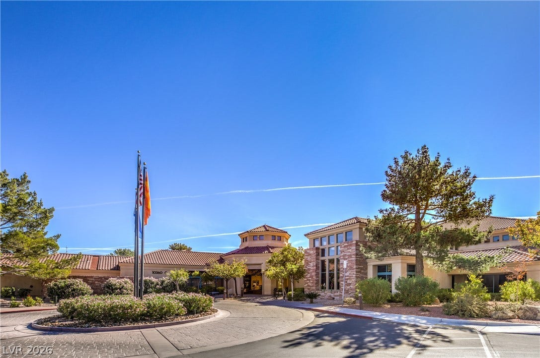 10700 Grand Cypress Avenue, Las Vegas, NV 89134 A grand exterior welcomes arrivals with a circular driveway and Mediterranean-inspired architecture.