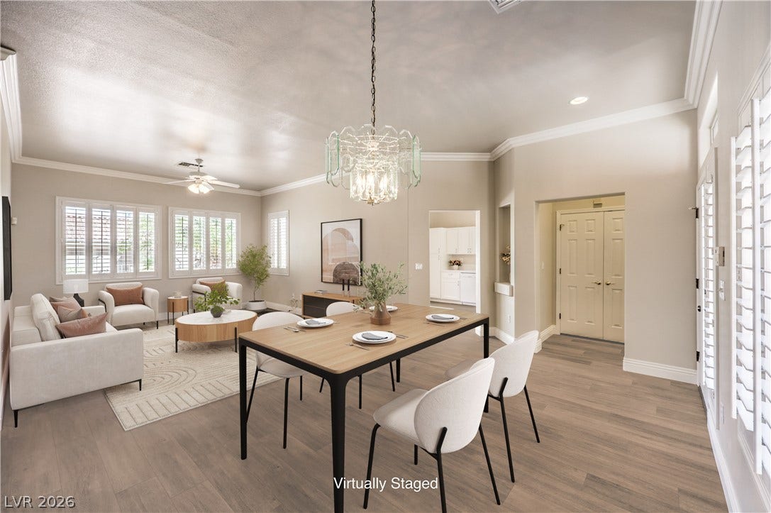 10700 Grand Cypress Avenue, Las Vegas, NV 89134 Crown molding and wide-plank flooring elevate this versatile open-concept dining area.