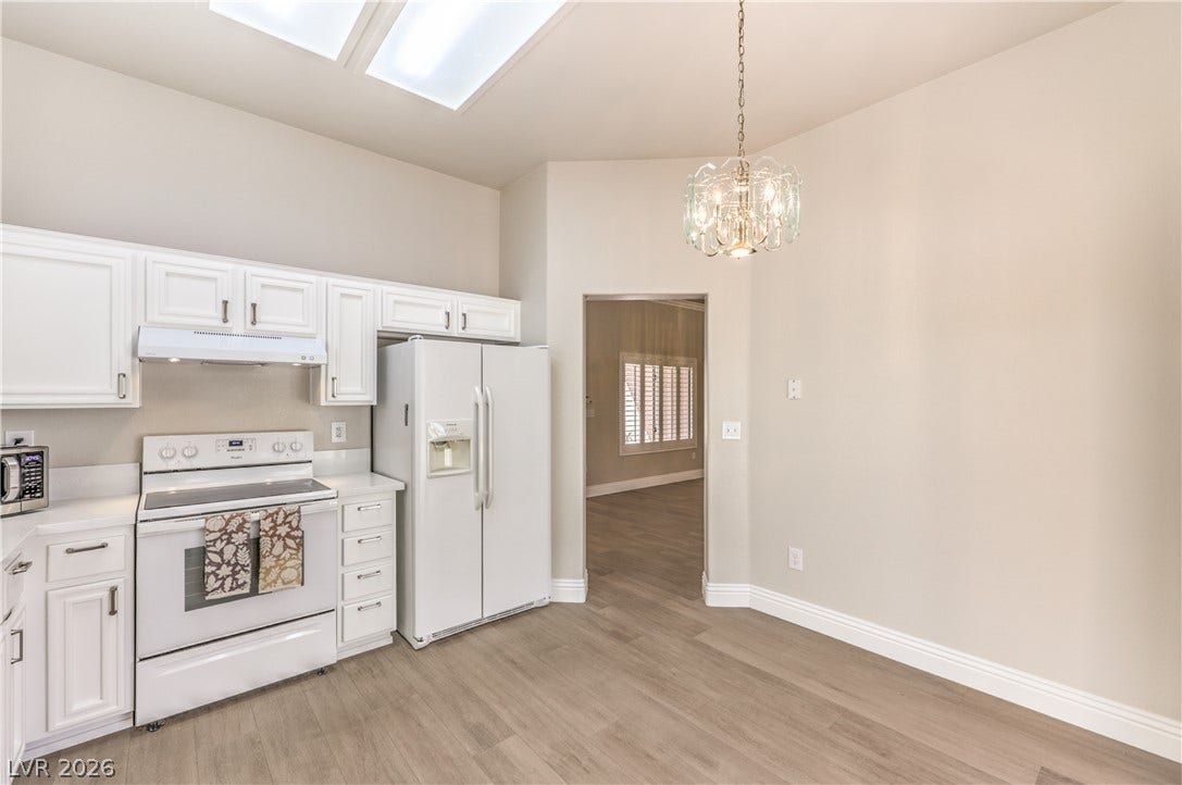 10700 Grand Cypress Avenue, Las Vegas, NV 89134 Gleaming wood floors and a sun-filtering skylight define this bright, open kitchen space.