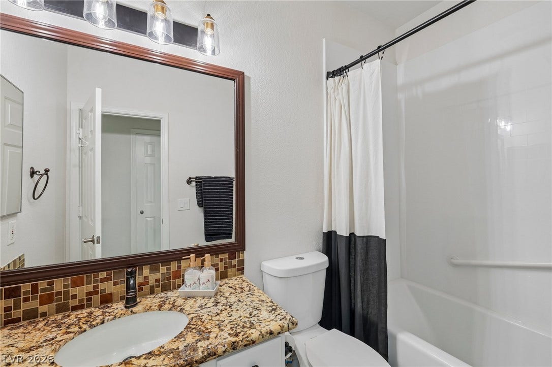3027 Panorama Ridge Drive, Henderson, NV 89052 Rich stone counters and tiled accents highlight this welcoming bathroom design.