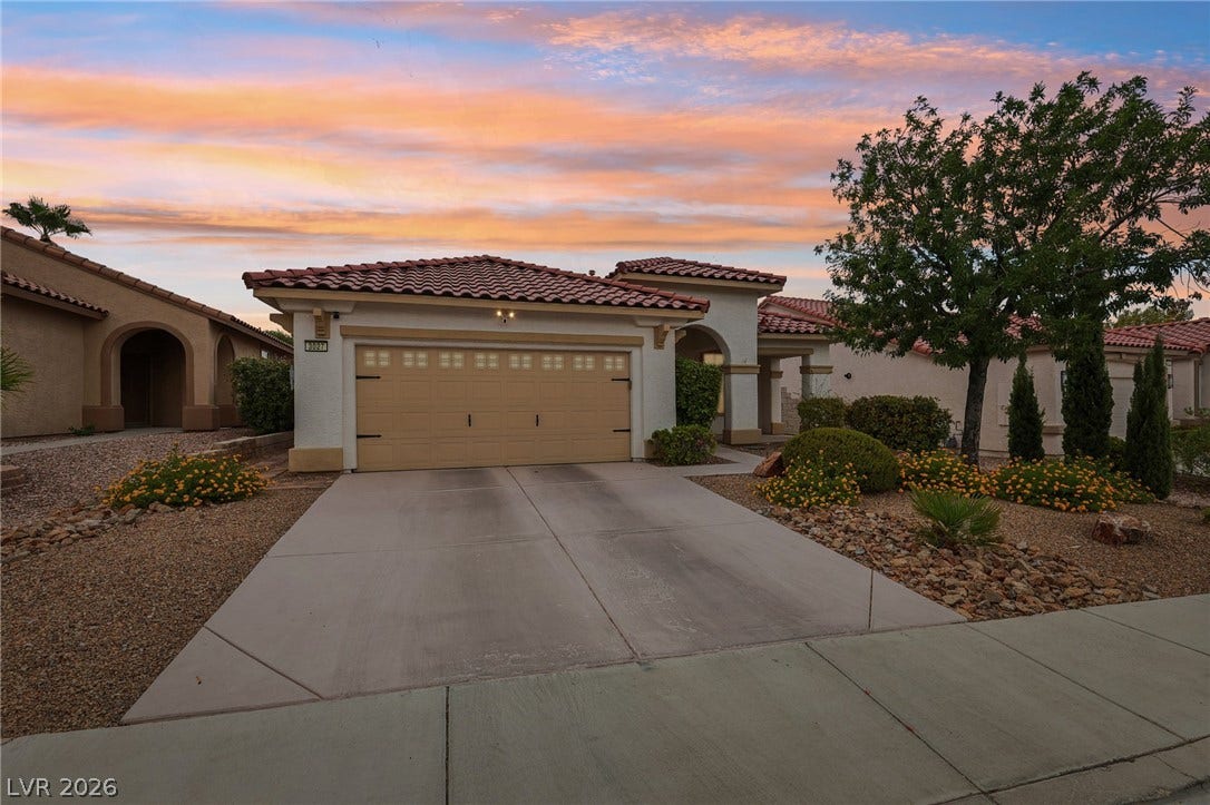 3027 Panorama Ridge Drive, Henderson, NV 89052 Clay tile roofing and desert-friendly landscaping frame this charming stucco home with an attached garage.
