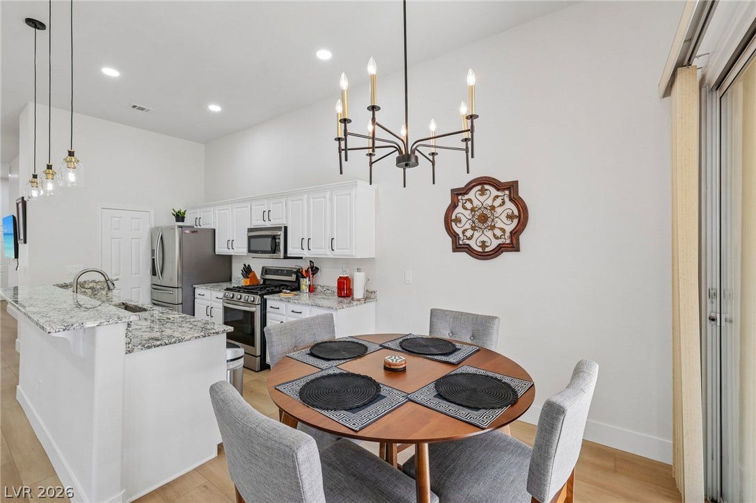 3027 Panorama Ridge Drive, Henderson, NV 89052 An open floorplan seamlessly connects the dining space and kitchen under high ceilings.