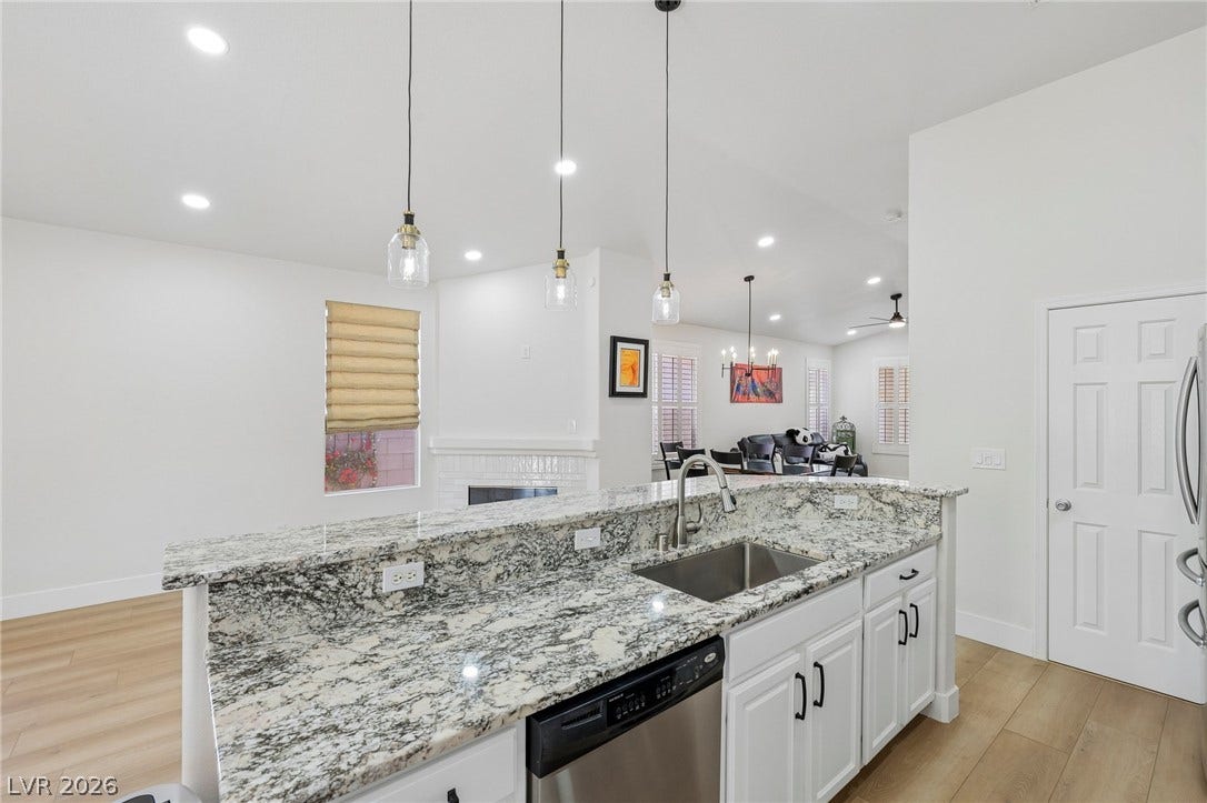 3027 Panorama Ridge Drive, Henderson, NV 89052 Polished stone counters and recess lighting define this open concept kitchen design.