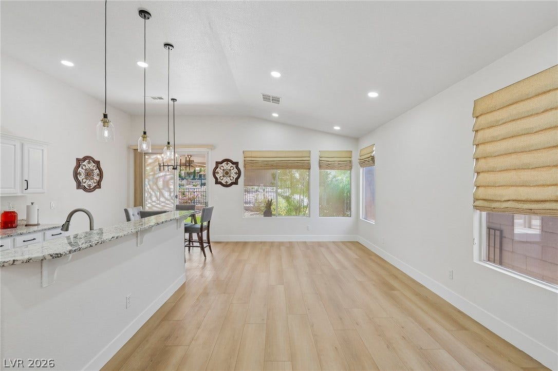 3027 Panorama Ridge Drive, Henderson, NV 89052 An open layout flows seamlessly over light Luxury-plank flooring under vaulted ceilings.