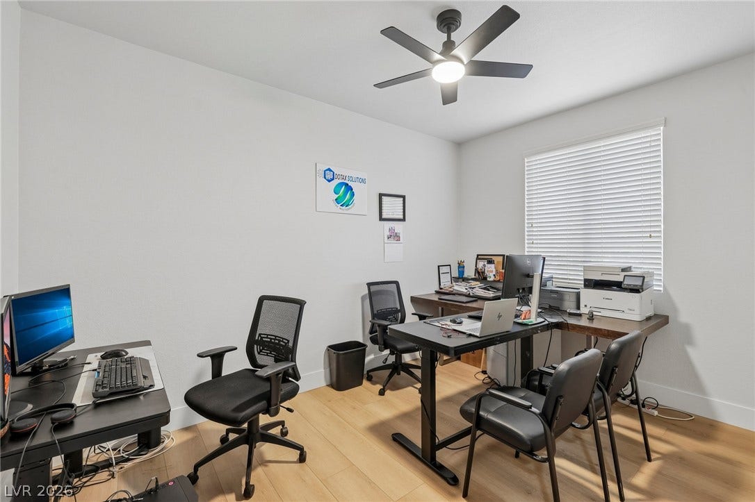3027 Panorama Ridge Drive, Henderson, NV 89052 Smooth wood-like floors and a wide window create an inviting workspace environment.