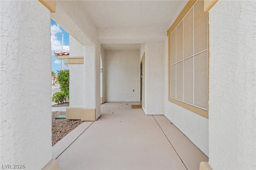 3027 Panorama Ridge Drive, Henderson, NV 89052 An inviting covered front porch features textured stucco pillars and smooth concrete flooring.