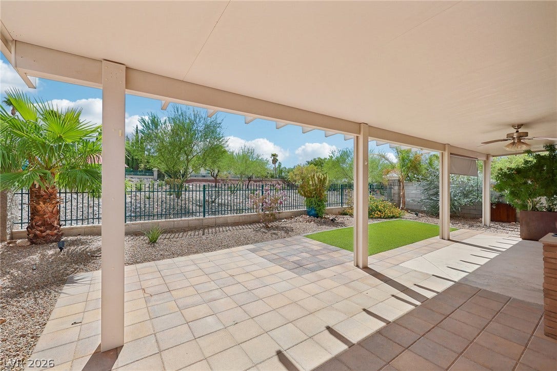 3027 Panorama Ridge Drive, Henderson, NV 89052 Shaded paving stones lead to a manicured lawn under a solid porch roof.