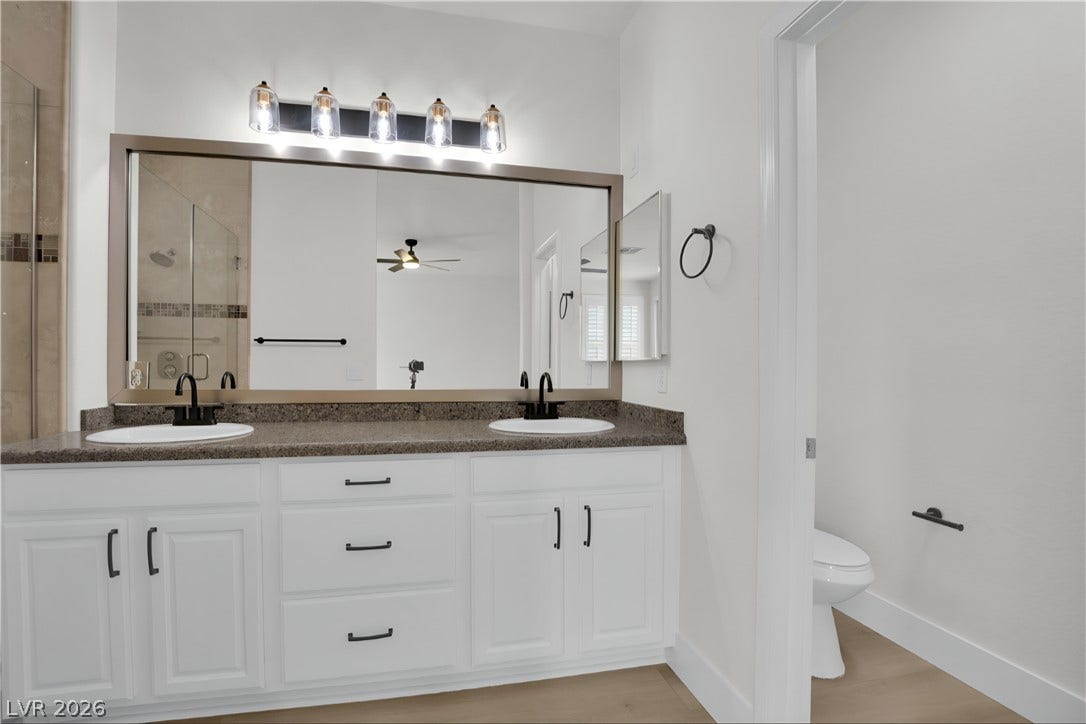 3027 Panorama Ridge Drive, Henderson, NV 89052 Granite counters and dual sinks elevate this modern bathroom design.