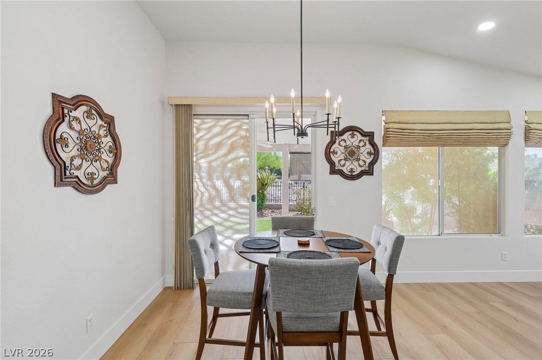 3027 Panorama Ridge Drive, Henderson, NV 89052 Hardwood floors and vaulted ceilings elevate this sunlit dining area with terrace access.